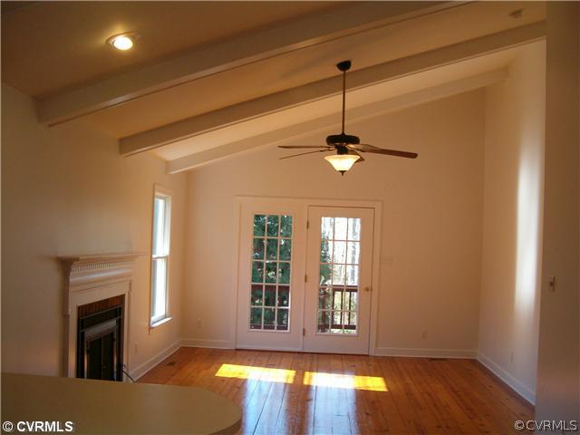 3938 Whitehall Road Sandy Hook, VA 23153 - Photo 8 of 23 a view of an empty room with window fireplace and wooden floor