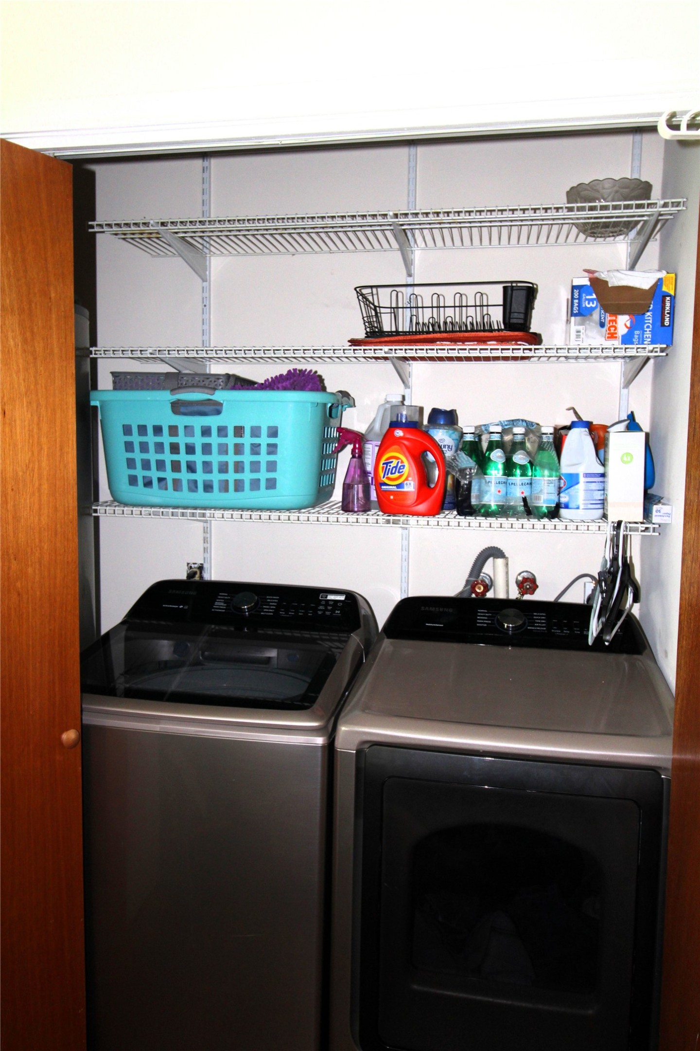 303 North 9th Street Beasley, TX 77417 - Photo 17 of 41 This photo shows a compact laundry area with a washer and dryer set. The space is efficiently organized for convenience.