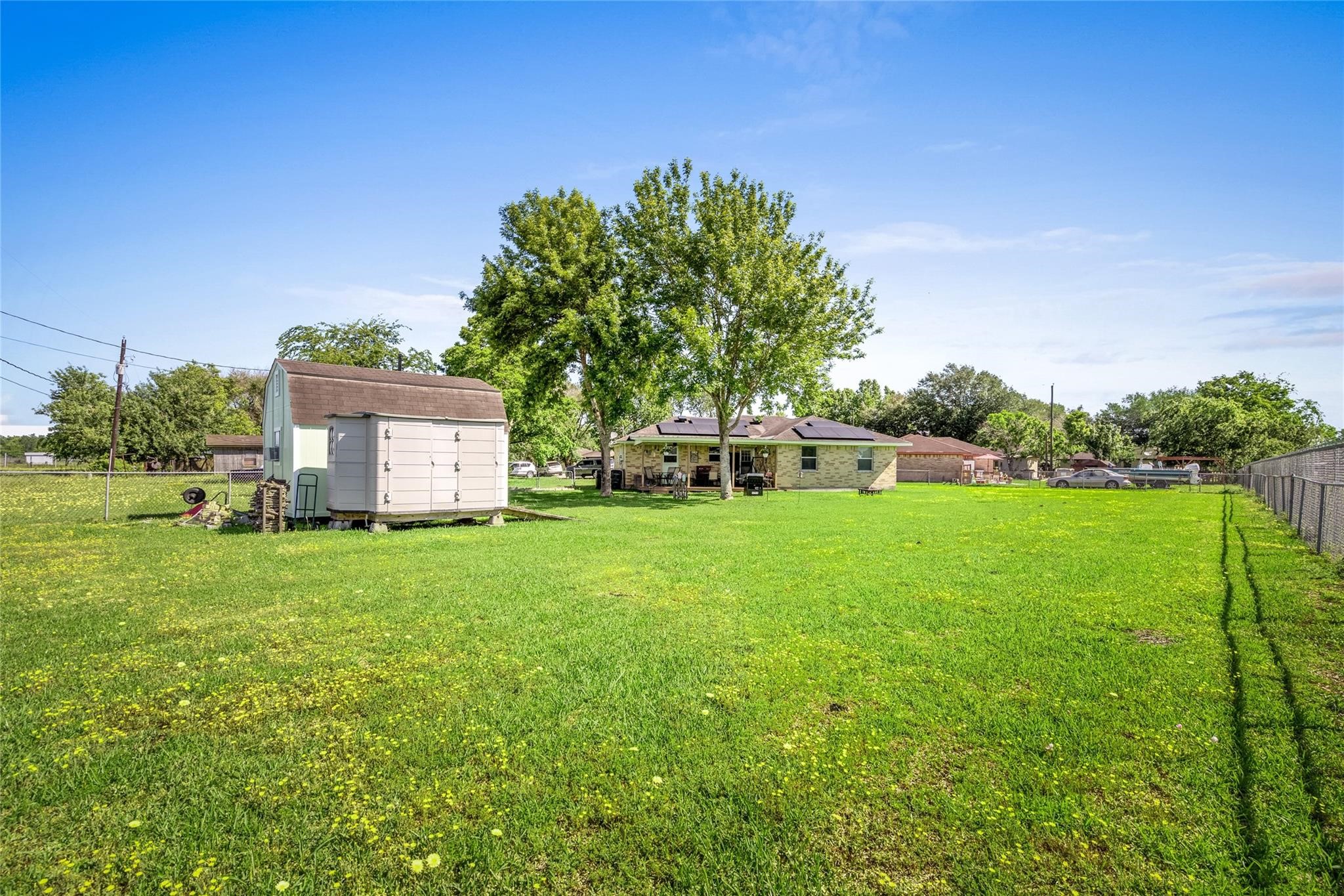 303 North 9th Street Beasley, TX 77417 - Photo 24 of 41 Spacious backyard with lots of room for the children and pets to roam and play safely in the fenced area.