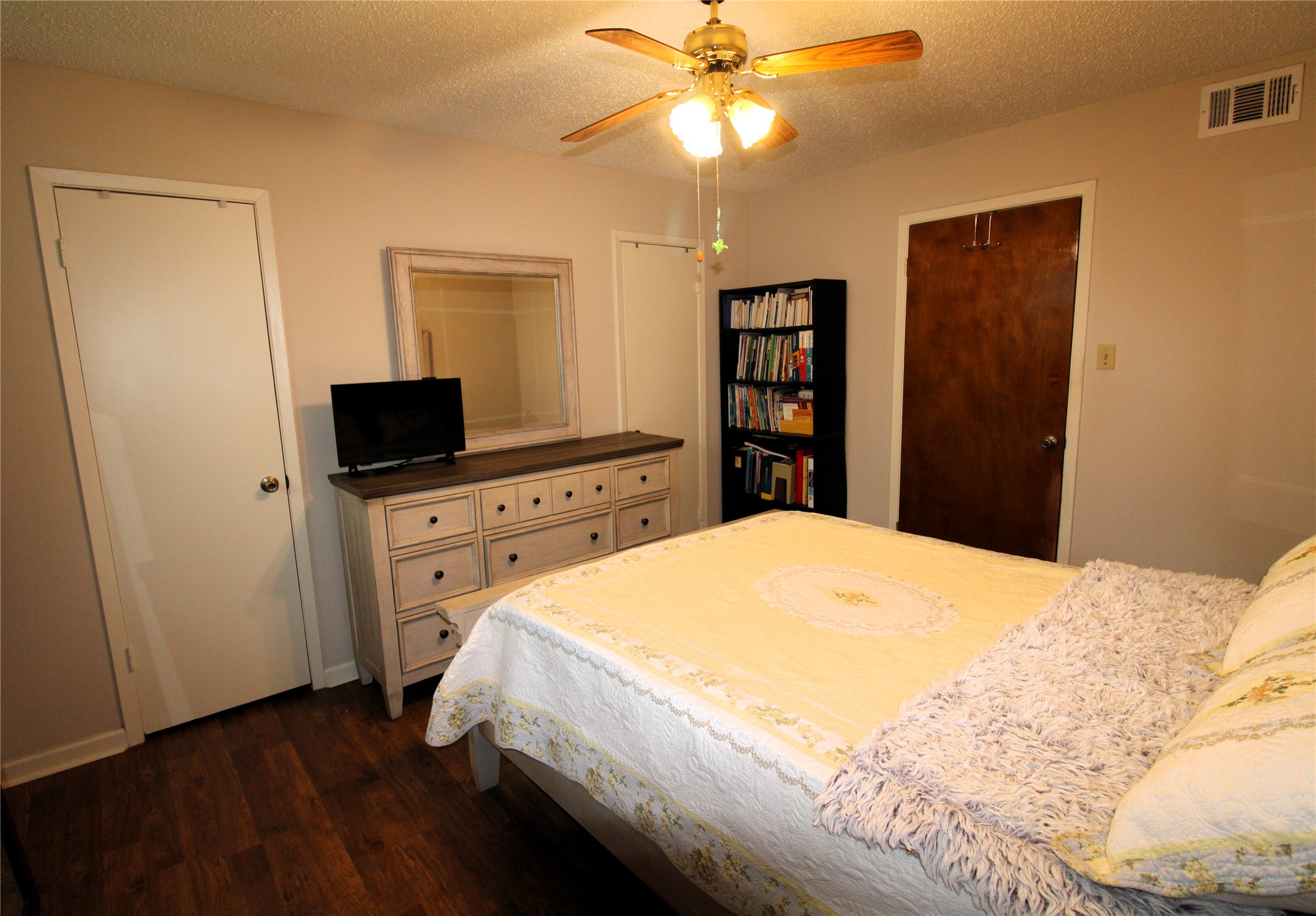 303 North 9th Street Beasley, TX 77417 - Photo 29 of 41 Primary has double closets, wood flooring and ceiling fan!