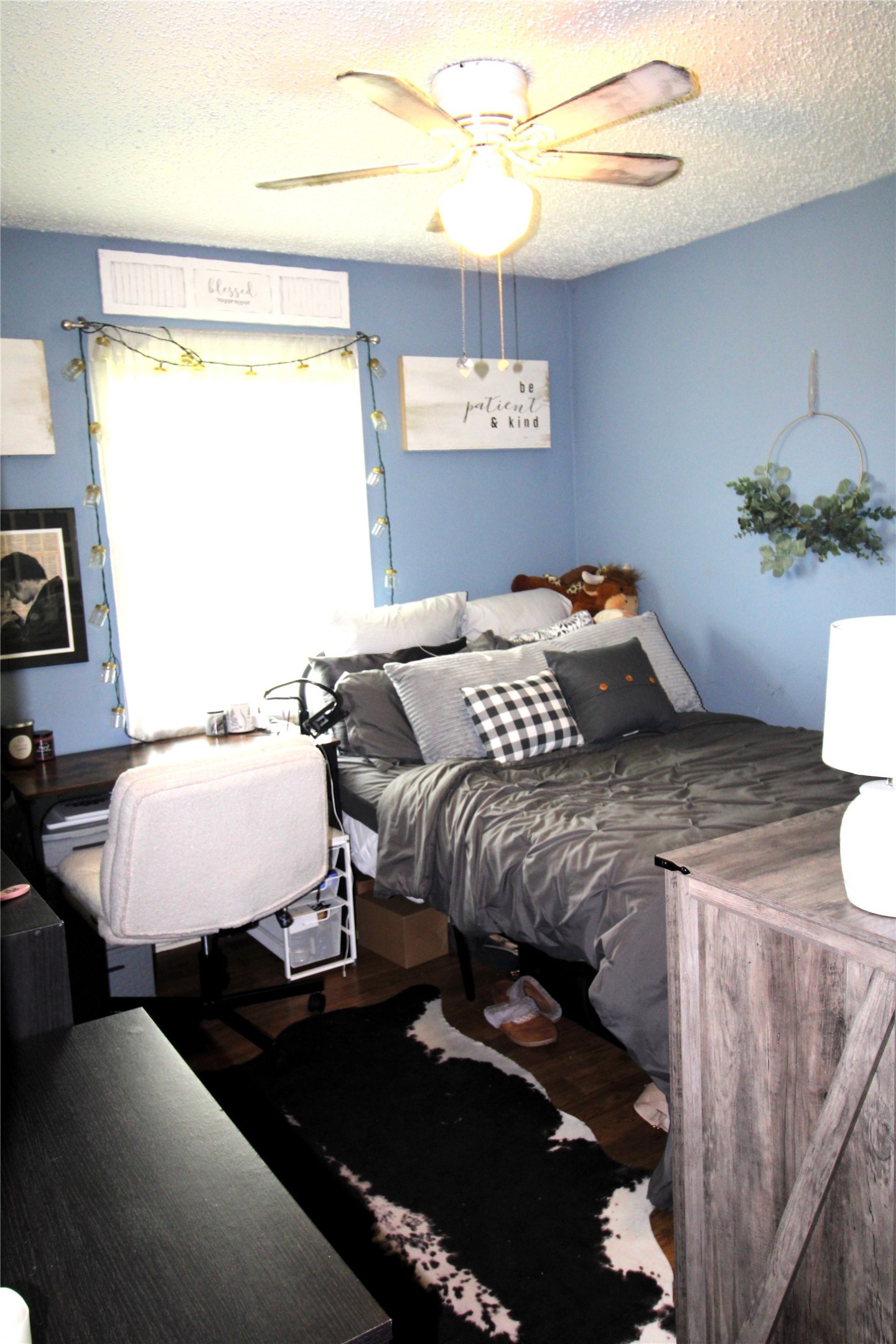 303 North 9th Street Beasley, TX 77417 - Photo 35 of 41 This view features lots of light with window ample storage and a neatly arranged bed with a patterned quilt. A small shelving unit provides additional organization.