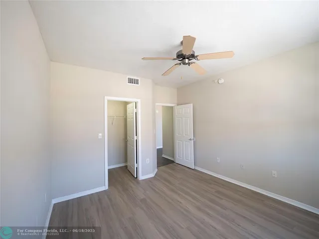 a bathroom with a granite countertop bathtub shower sink vanity and toilet