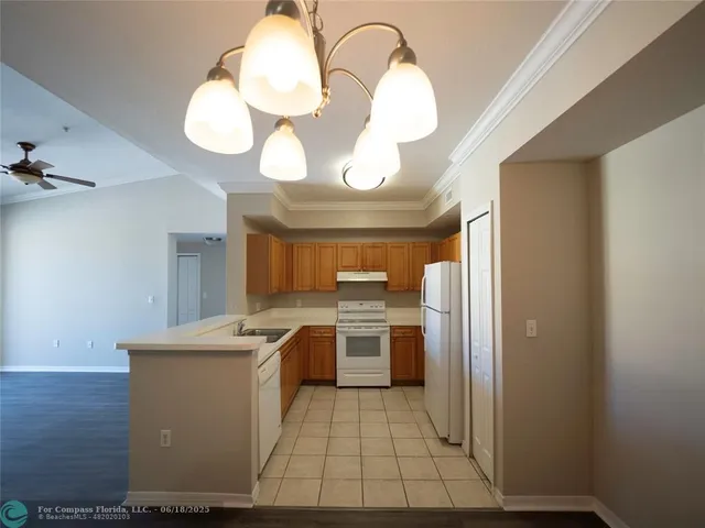 a view of a kitchen with wooden floor and a sink