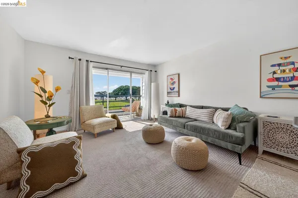 a living room with furniture and a large window