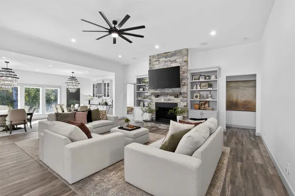 a living room with a bed furniture and a flat tv screen