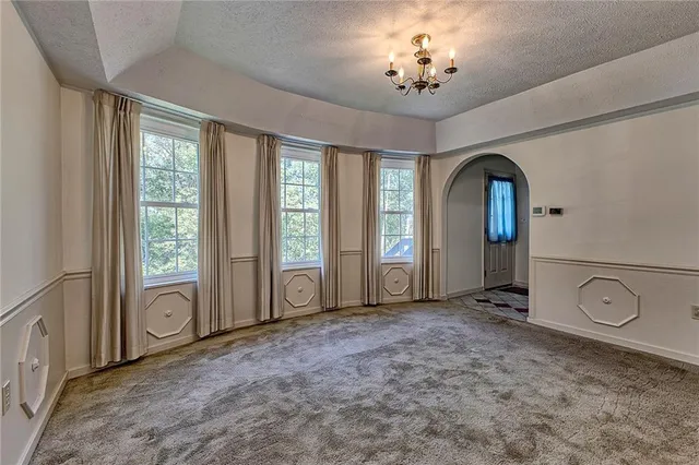 a view of a livingroom with an empty space and a window
