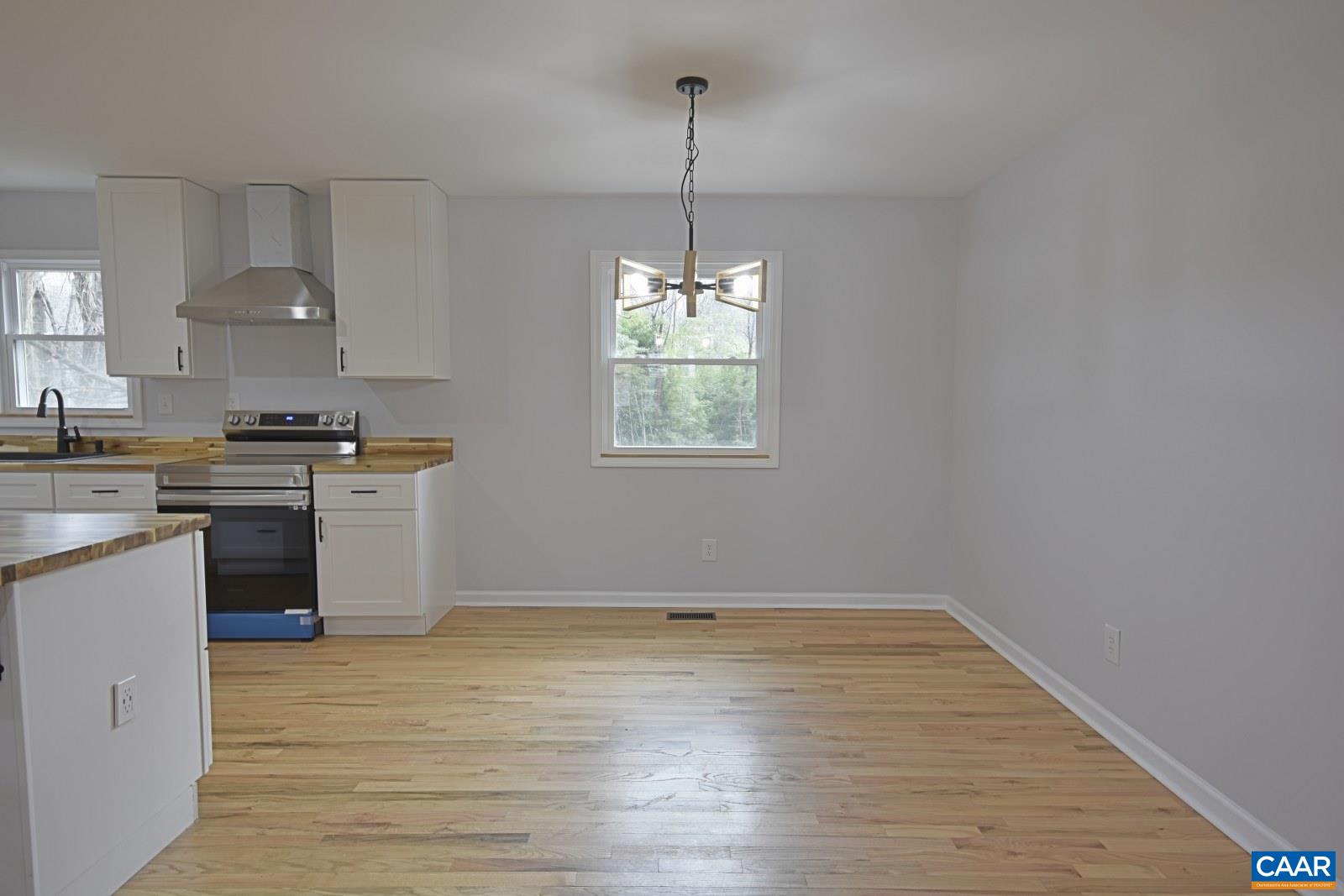 330 Brentwood Road Charlottesville, VA 22901 - Photo 11 of 26 a kitchen with granite countertop a stove a sink wooden floor and cabinets