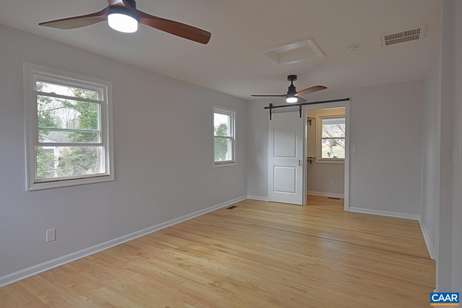 330 Brentwood Road Charlottesville, VA 22901 - Photo 12 of 26 an empty room with windows and cabinet