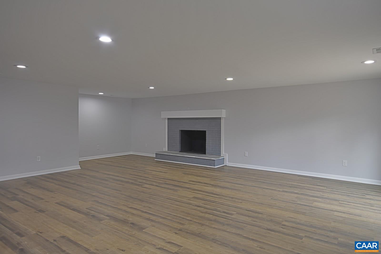 330 Brentwood Road Charlottesville, VA 22901 - Photo 18 of 26 an empty room with wooden floor and a fireplace