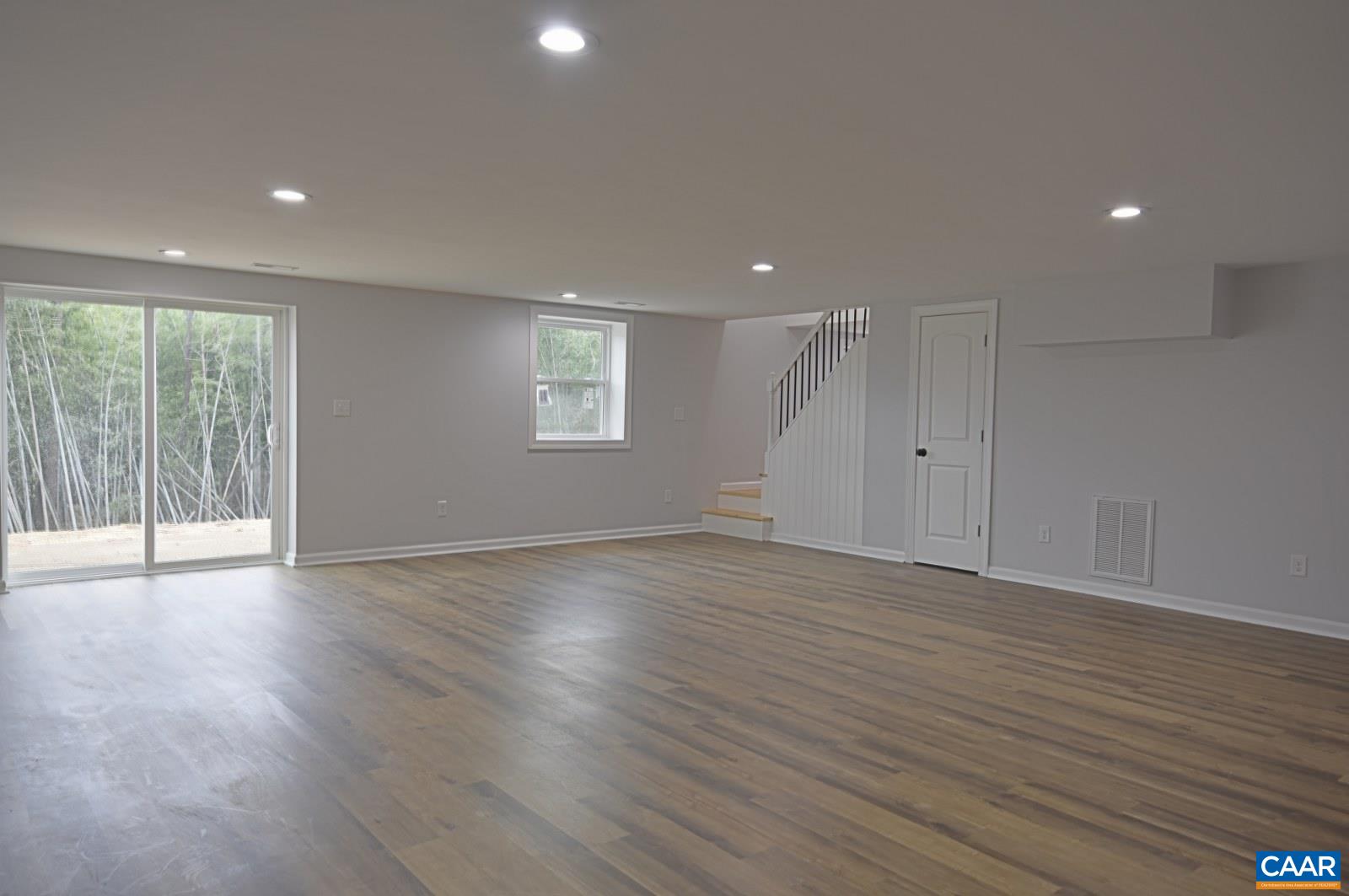330 Brentwood Road Charlottesville, VA 22901 - Photo 20 of 26 an empty room with wooden floor and windows
