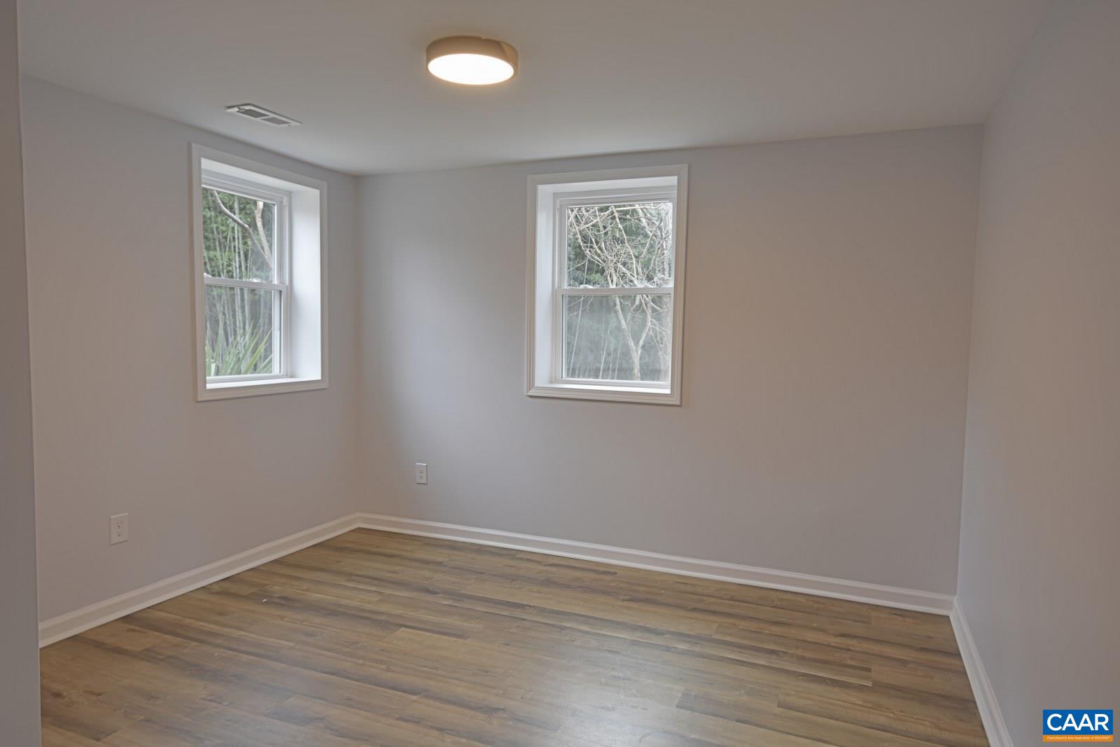 330 Brentwood Road Charlottesville, VA 22901 - Photo 22 of 26 a view of an empty room with wooden floor and a window