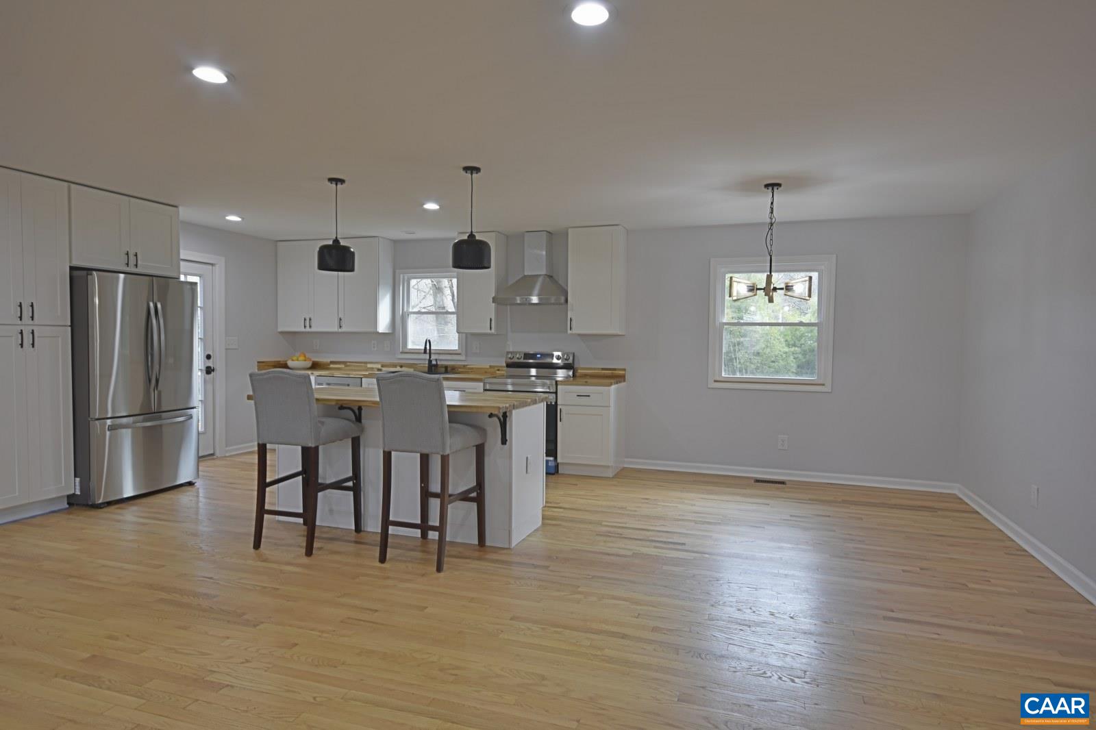 330 Brentwood Road Charlottesville, VA 22901 - Photo 3 of 26 a view of kitchen with refrigerator microwave and wooden floor