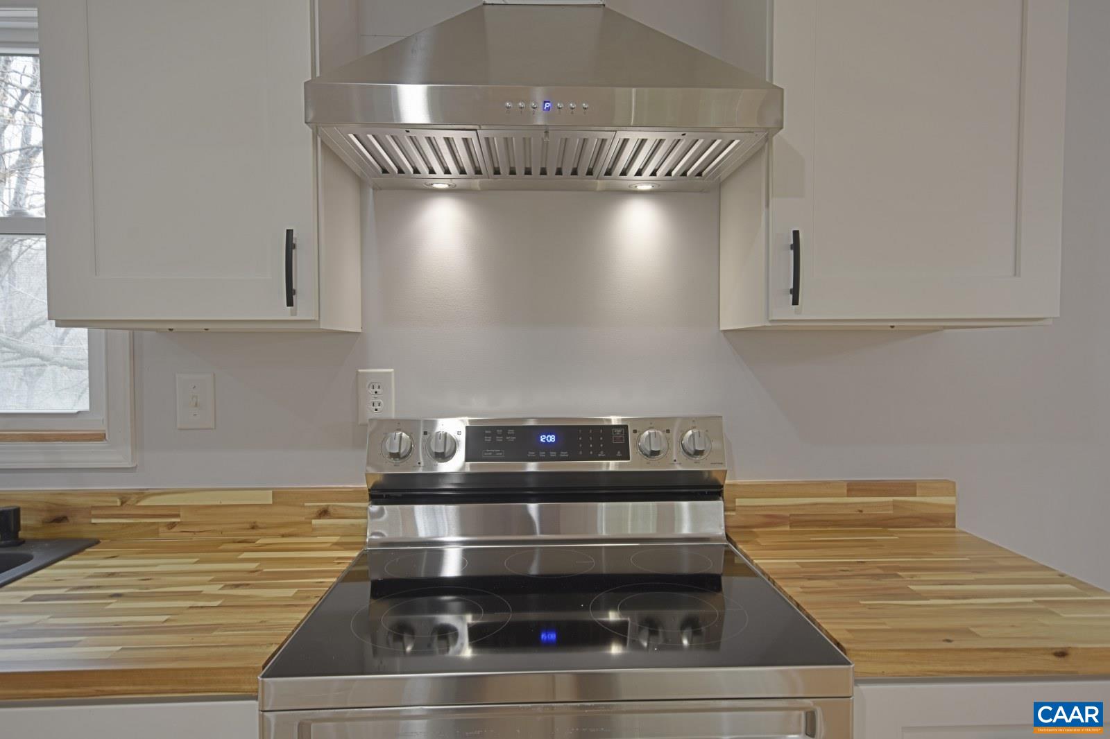 330 Brentwood Road Charlottesville, VA 22901 - Photo 7 of 26 a kitchen with granite countertop a stove and white cabinets