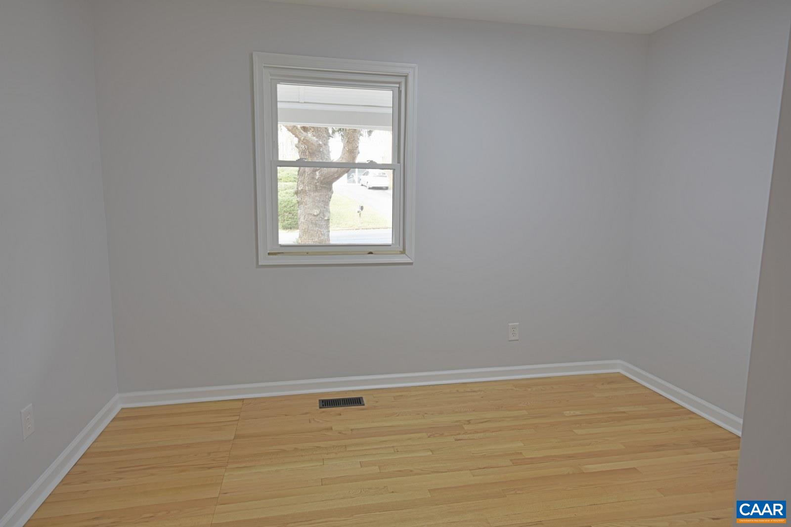 330 Brentwood Road Charlottesville, VA 22901 - Photo 10 of 26 a view of an empty room with wooden floor and a window