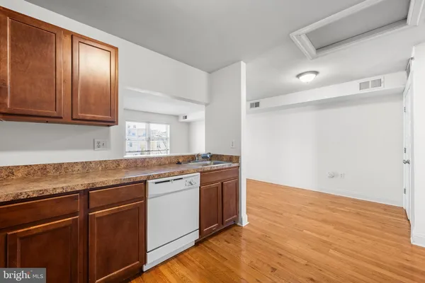 a kitchen with stainless steel appliances granite countertop wooden cabinets and sink