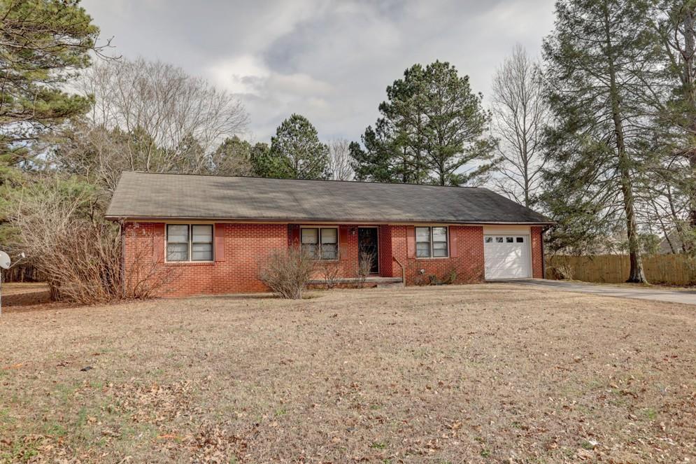 11255 Jones Bridge Road Alpharetta, GA 30022 - Photo 1 of 1 a front view of a house with a yard