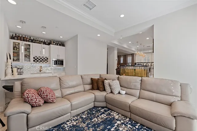 a living room with furniture and kitchen view