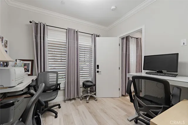 a view of a workspace with furniture and a flat screen tv