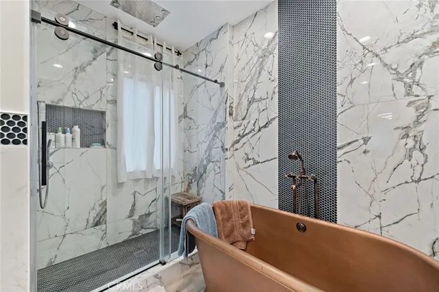 a bathroom with a bathtub and shower