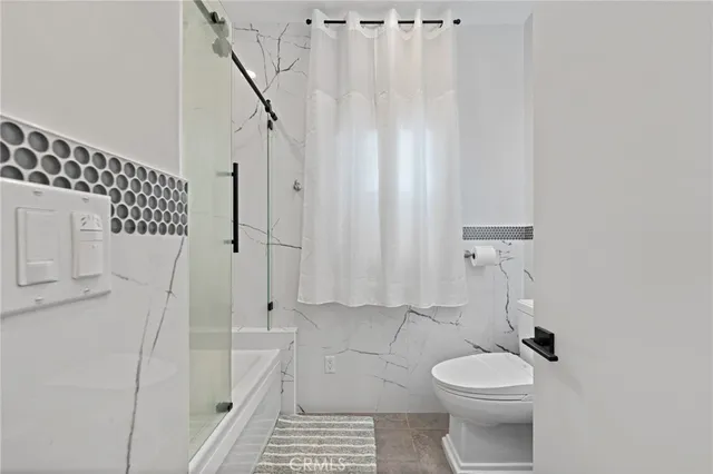 a white toilet sitting next to a bathroom sink