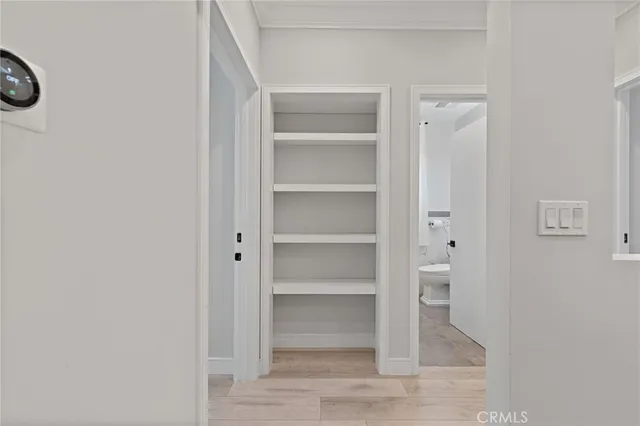 a view of walk in closet with empty racks