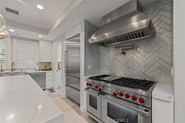 a kitchen with a stove and a refrigerator