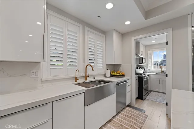 a kitchen that has a sink and a stove