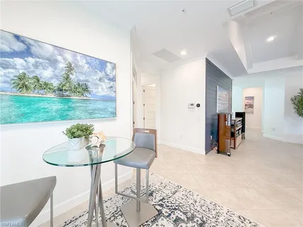 a living room with furniture and a kitchen