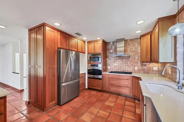 a kitchen with a sink window and cabinets