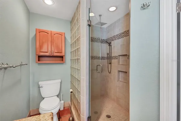 a bathroom with a toilet a sink a mirror and vanity