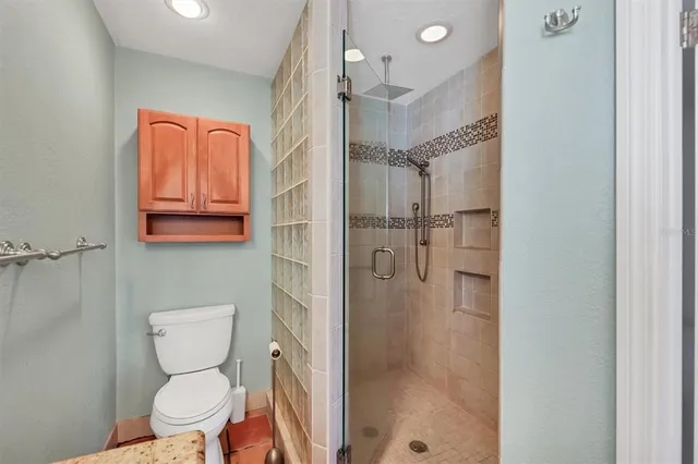 a bathroom with a toilet a sink a mirror and vanity