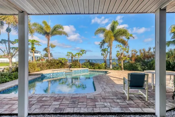 a view of a house with swimming pool and sitting area