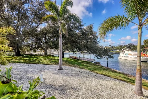 a view of a yard with wooden fence