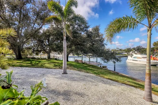 a view of a yard with wooden fence