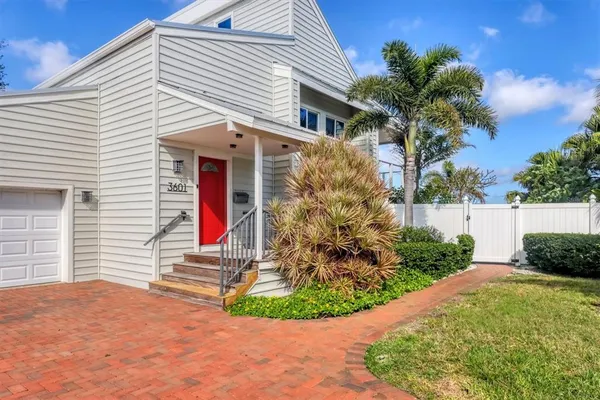 a view of a house with small yard and plants