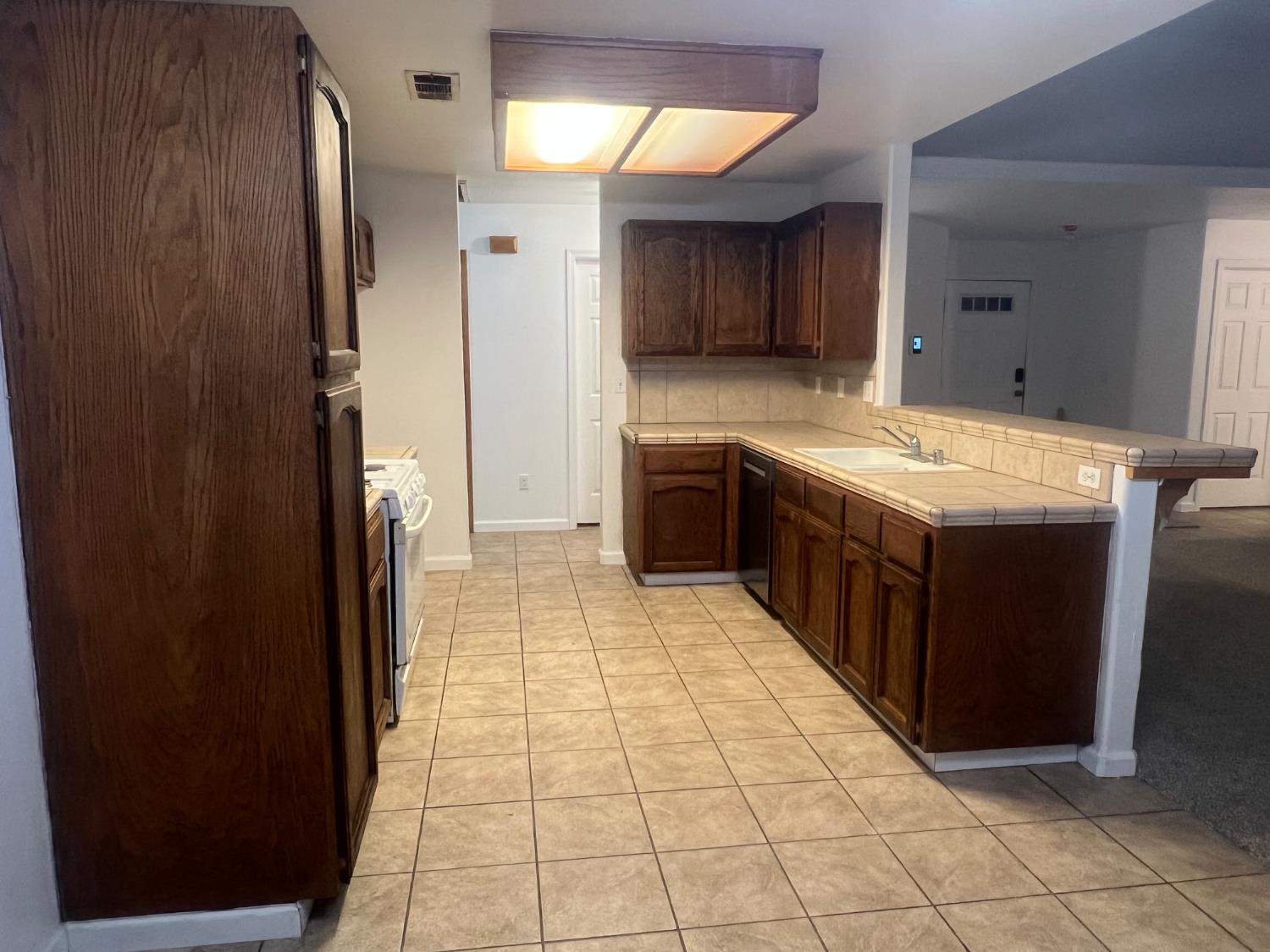 946 West Mammoth Pool Way Hanford, CA 93230 - Photo 15 of 17 a kitchen with stainless steel appliances granite countertop a refrigerator and a sink
