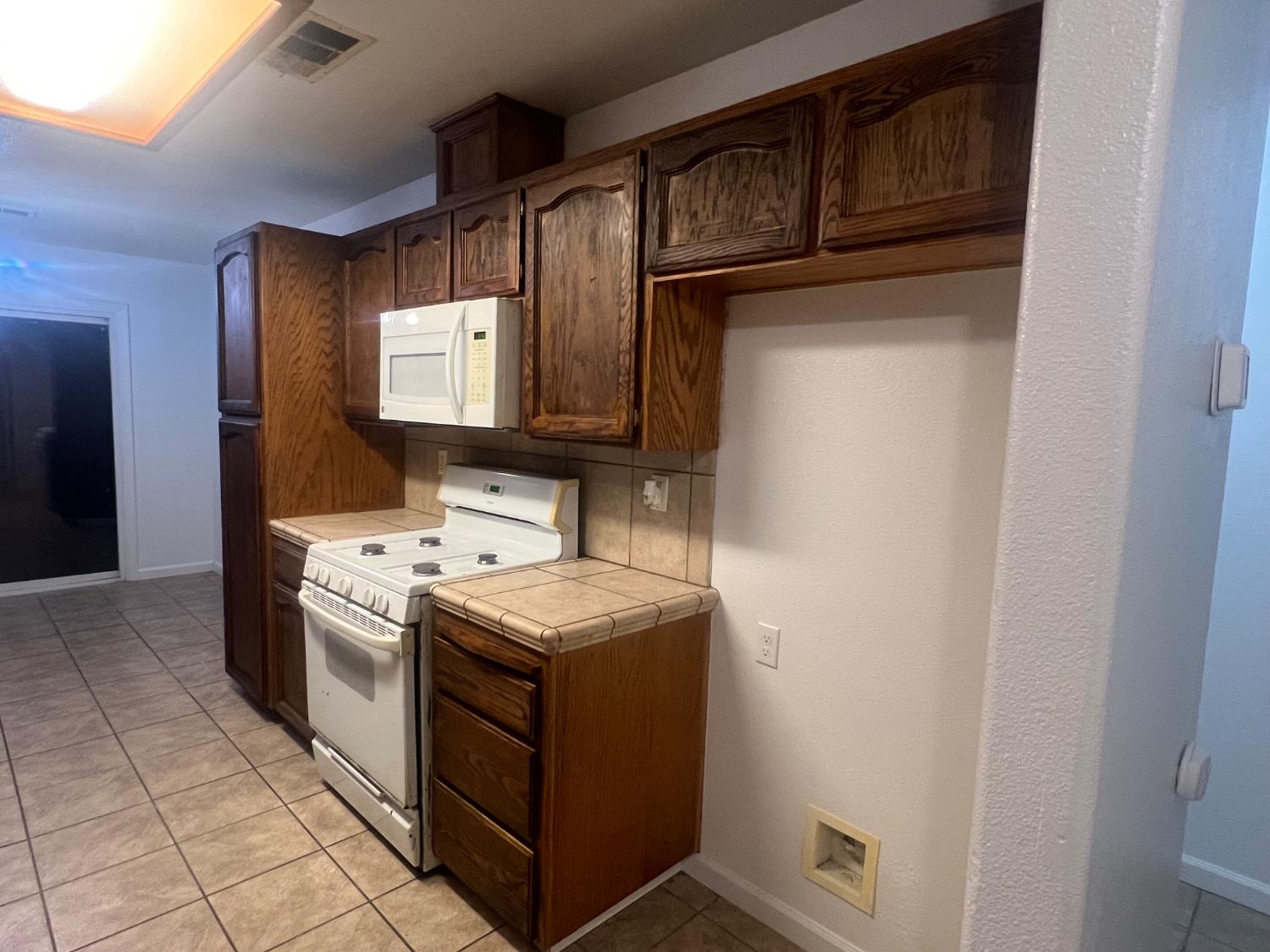 946 West Mammoth Pool Way Hanford, CA 93230 - Photo 17 of 17 a kitchen with a stove sink and cabinets