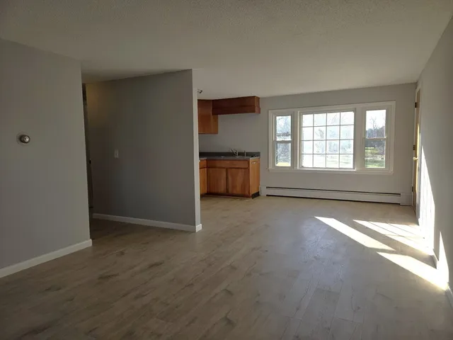 an empty room with a empty space and windows