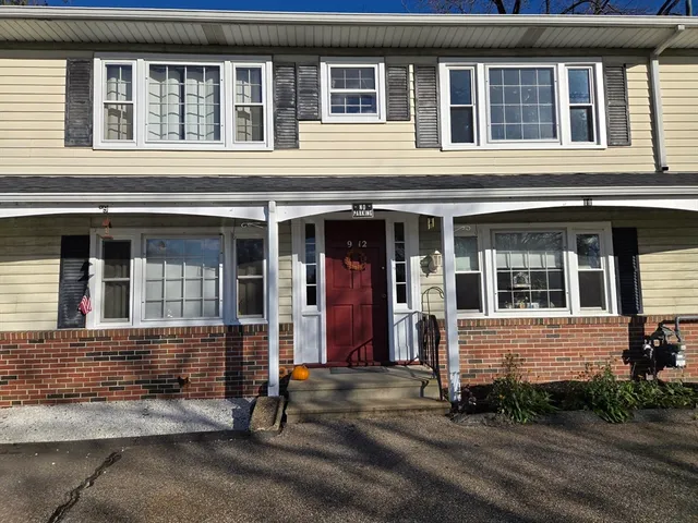 front view of brick house with large windows