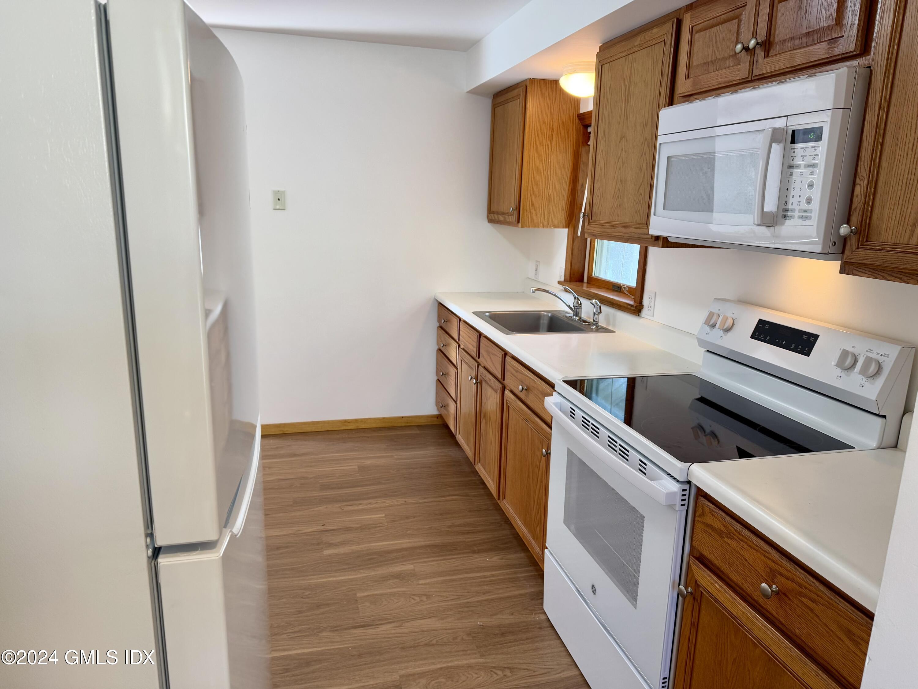 137 South Water Street, Unit 1B Greenwich, CT 06830 - Photo 2 of 13 a kitchen that has a sink and a stove in it