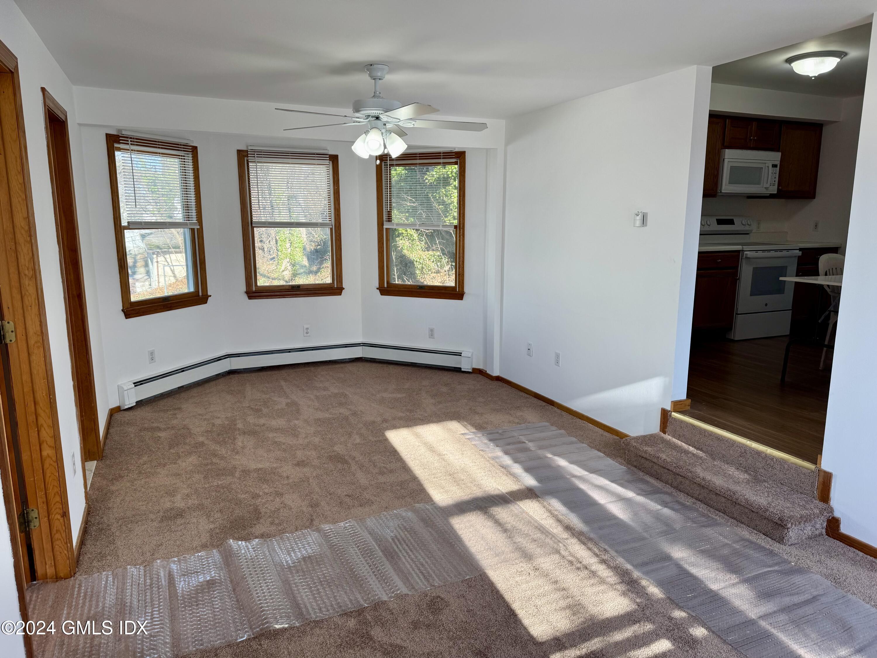 137 South Water Street, Unit 1B Greenwich, CT 06830 - Photo 4 of 13 an empty room with windows
