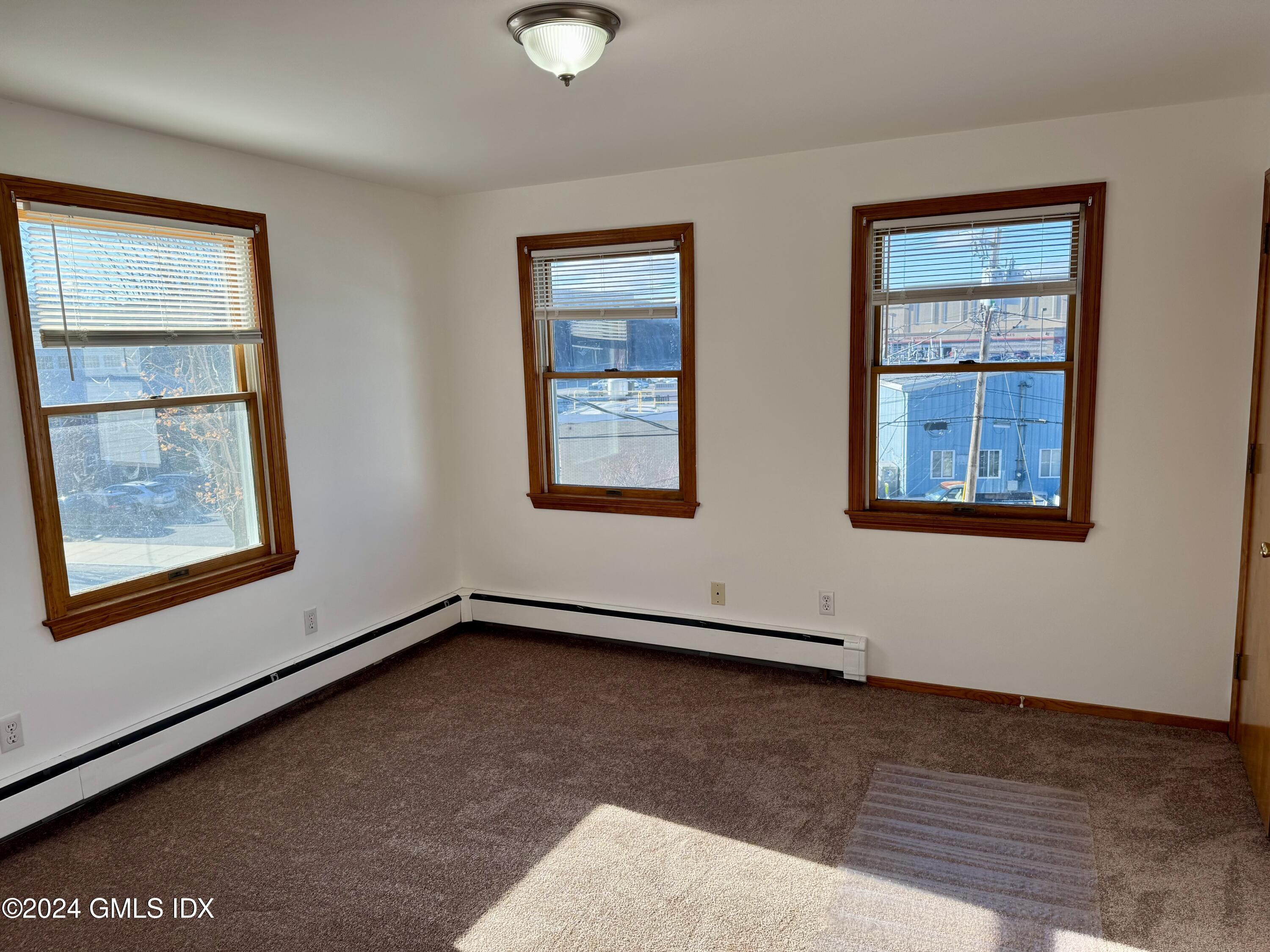 137 South Water Street, Unit 1B Greenwich, CT 06830 - Photo 5 of 13 a view of an empty room with a window