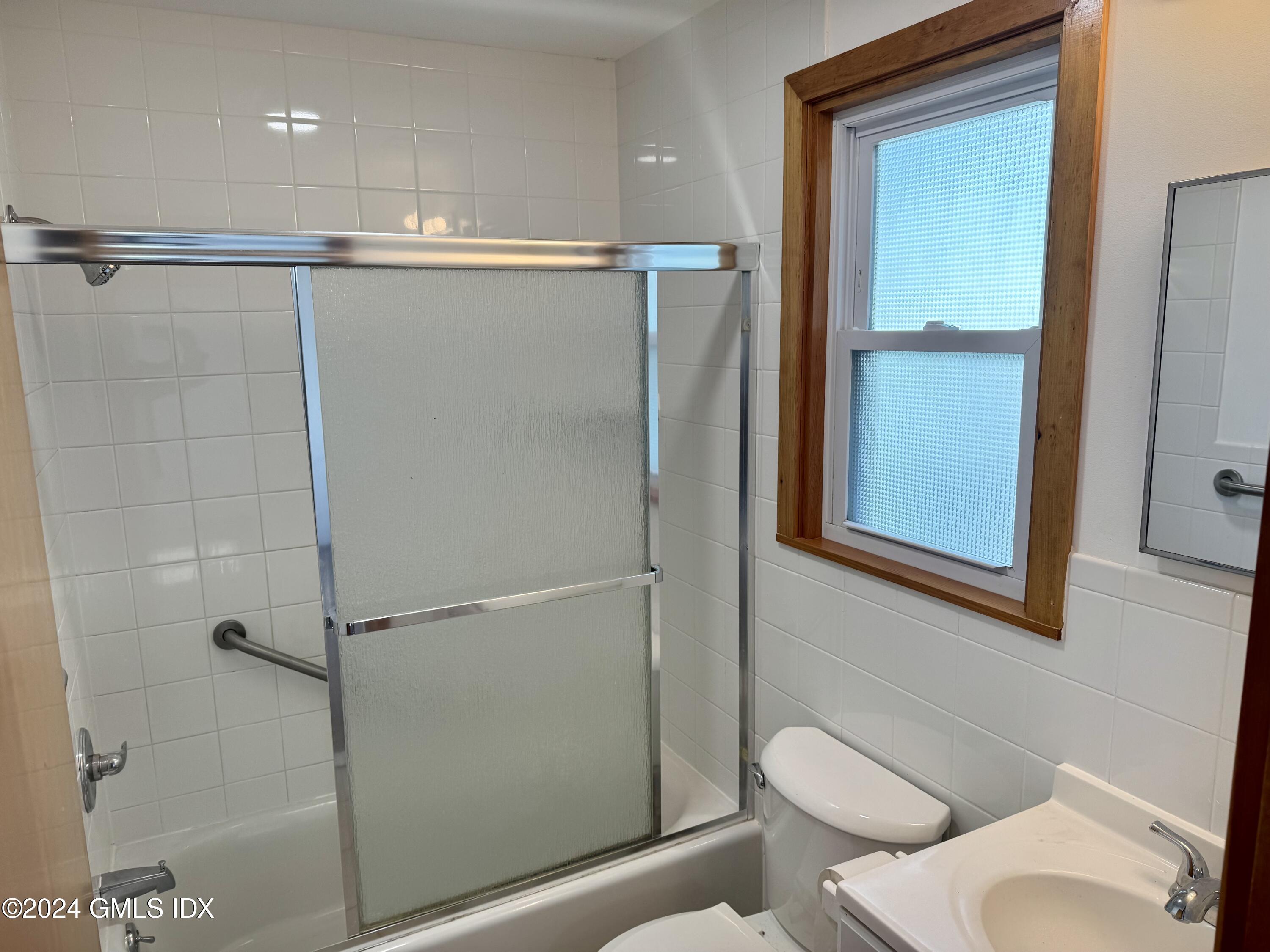 137 South Water Street, Unit 1B Greenwich, CT 06830 - Photo 7 of 13 a bathroom with a shower a toilet and a sink