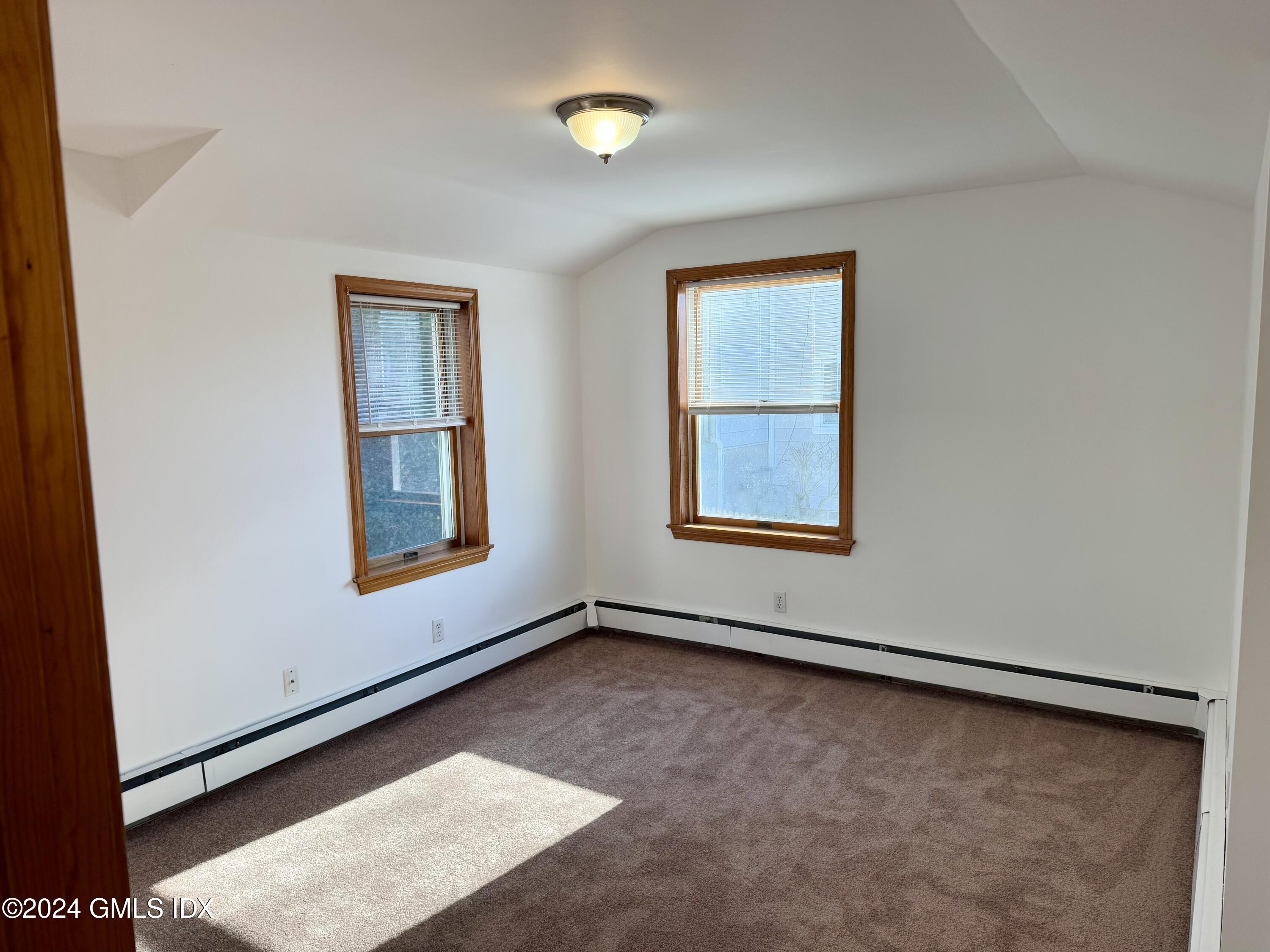 137 South Water Street, Unit 1B Greenwich, CT 06830 - Photo 8 of 13 an empty room with windows