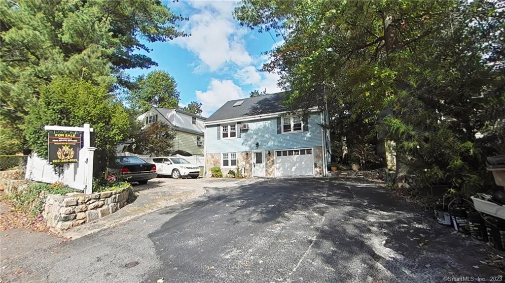 21 Pepper Ridge Road Stamford, CT 06905 - Photo 1 of 1 a view of a house with a large tree and many windows