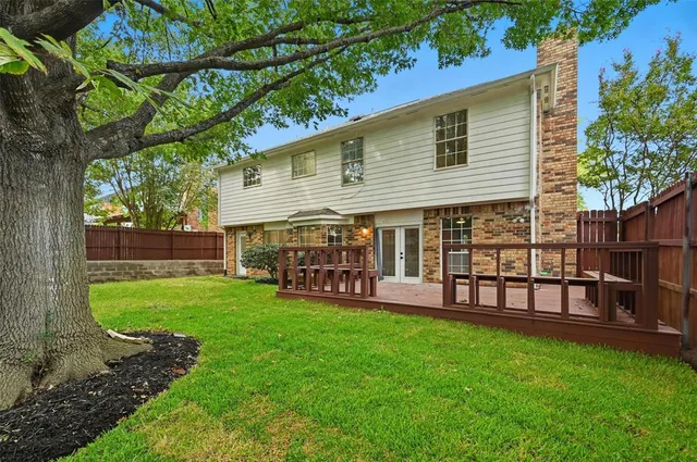 a view of a house with a yard and sitting area
