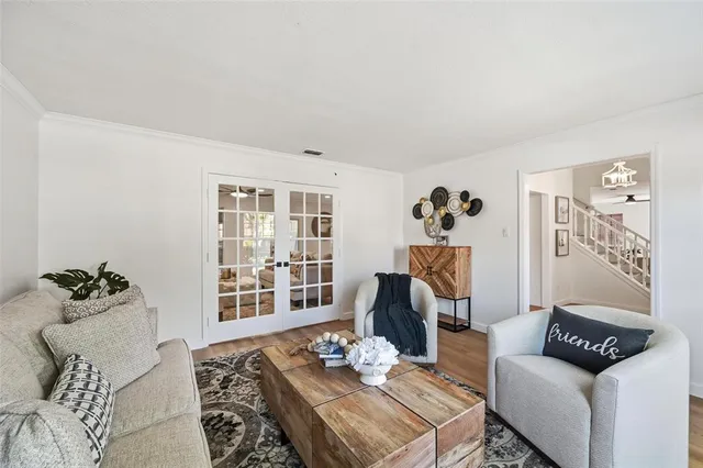 a living room with furniture and flowers