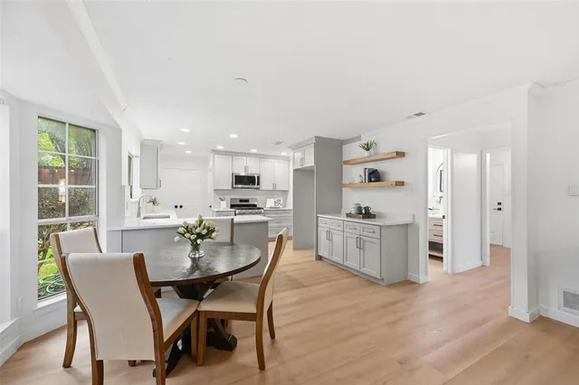 a view of a dining room with furniture and wooden floor