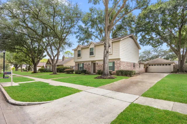 a view of a white house with a small yard
