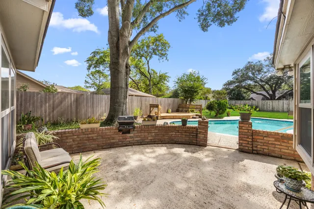 a view of a backyard with sitting area